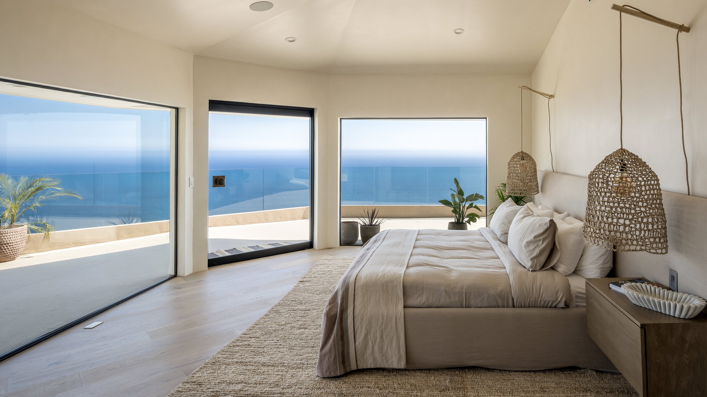 A calm bedroom with ocean views, freshly made
